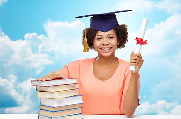 Image showing happy african bachelor girl with books and diploma