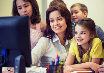 Image showing group of kids with teacher and computer at school