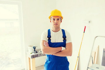 Image showing builder in hardhat with working tools indoors