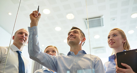 Image showing smiling business people with marker and stickers