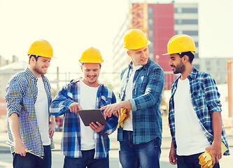 Image showing group of smiling builders with tablet pc outdoors