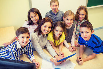 Image showing group of kids with teacher and tablet pc at school