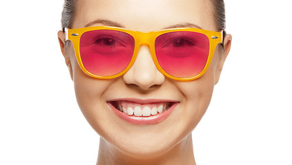 Image showing smiling teenage girl in pink sunglasses