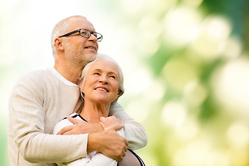 Image showing happy senior couple over green natural background