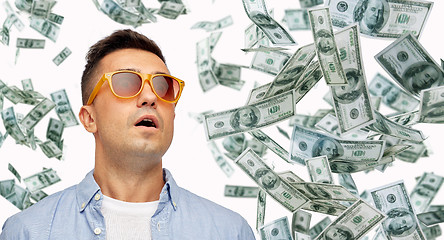 Image showing surprised man under dollar money rain