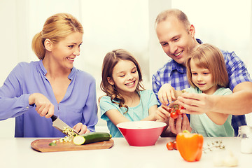 Image showing happy family with two kids making dinner at home