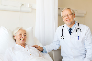 Image showing doctor visiting senior woman at hospital ward