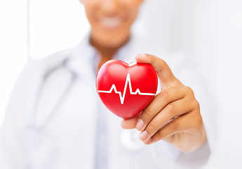 Image showing female doctor holding red heart with ecg line