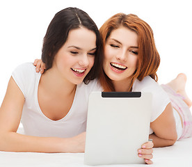 Image showing two smiling teenage girsl with tablet pc computer