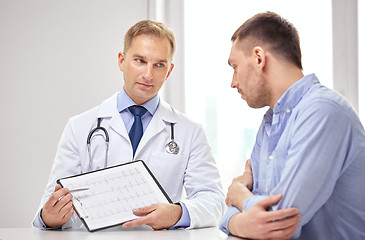 Image showing doctor and patient with cardiogram on clipboard