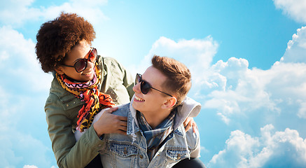 Image showing happy teenage couple in shades having fun outdoors