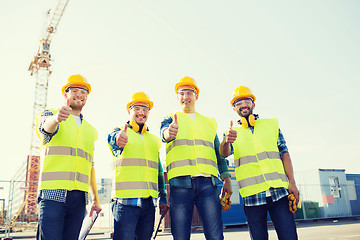 Image showing group of smiling builders with tablet pc outdoors
