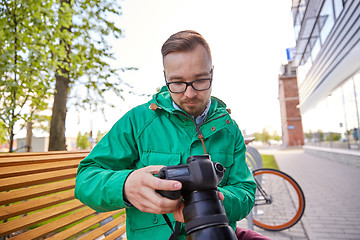 Image showing young hipster man with digital camera in city