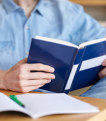 Image showing close up of student reading book at school