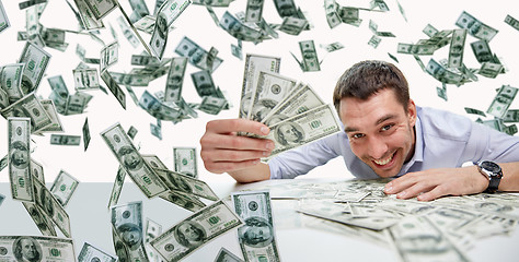 Image showing happy businessman with heap of money