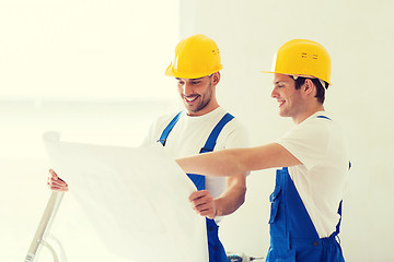Image showing group of builders with blueprint