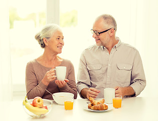 Image showing happy senior couple having breakfast at home