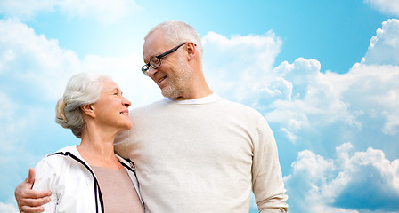 Image showing happy senior couple over blue sky and clouds