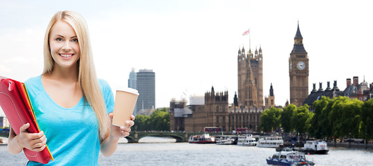 Image showing smiling student girl with folders and coffee cup