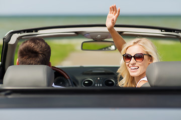 Image showing happy man and woman driving in cabriolet car