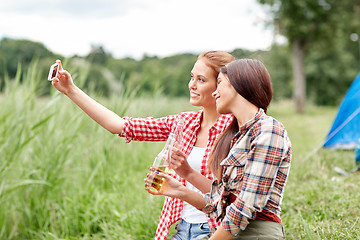 Image showing happy women taking selfie by smartphone at camping