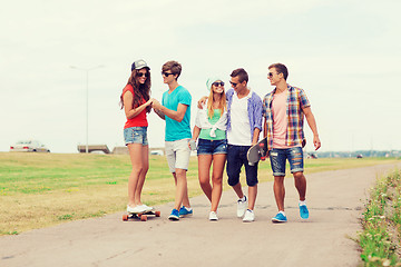 Image showing group of smiling teenagers with skateboards