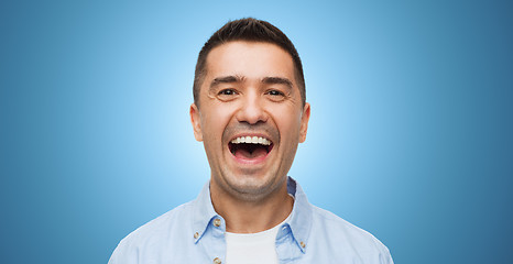 Image showing laughing man over blue background