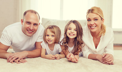 Image showing parents and two girls lying on floor at home