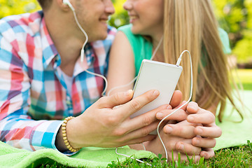 Image showing close up of couple with smartphone and earphones