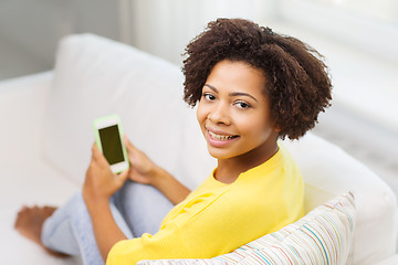 Image showing happy african woman with smartphone at home