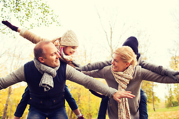 Image showing happy family having fun in autumn park