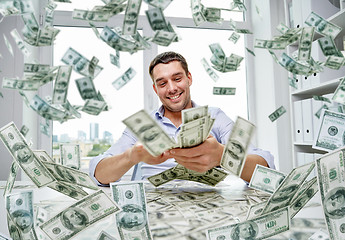 Image showing happy businessman with heap of money