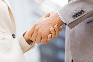 Image showing close up of business couple shaking hands