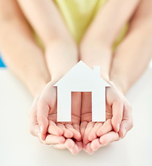 Image showing close up of woman and girl hands with paper house