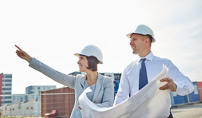 Image showing happy architects with blueprint at building