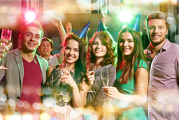 Image showing smiling friends with glasses of champagne in club