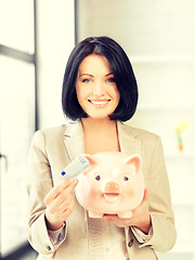 Image showing lovely woman with piggy bank and money