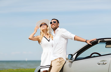 Image showing happy man and woman hugging near car at sea