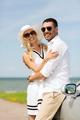 Image showing happy man and woman hugging near car at sea