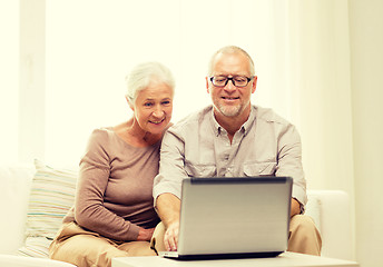Image showing happy senior couple with laptop at home