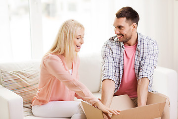 Image showing happy couple with open parcel box at home