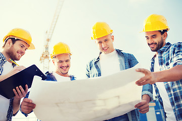 Image showing group of builders with tablet pc and blueprint