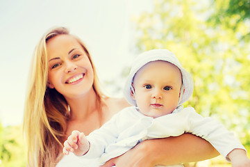 Image showing happy mother with little baby in park