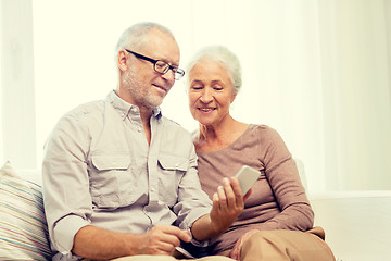 Image showing happy senior couple with smartphone at home