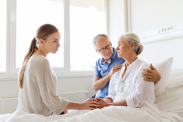 Image showing family visiting ill senior woman at hospital