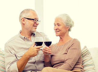 Image showing happy senior couple with glasses of red wine