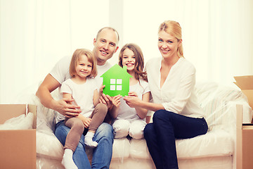 Image showing smiling parents and two little girls at new home