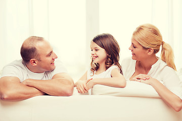 Image showing smiling parents and little girl at home