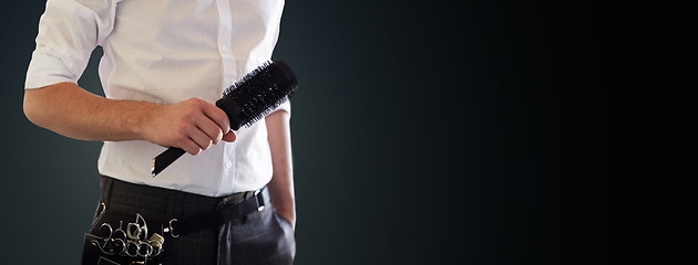 Image showing close up of male stylist with brush at salon