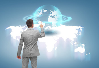 Image showing businessman pointing finger to globe projection